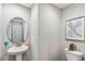 Small powder room with pedestal sink and toilet at 5009 Torchwood Dr, Minneola, FL 34715