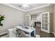 Home office with white desk, double doors and wood-look floors at 5009 Torchwood Dr, Minneola, FL 34715
