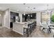 Modern kitchen with dark cabinetry, granite counters, and stainless steel appliances at 5009 Torchwood Dr, Minneola, FL 34715