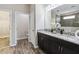 Double vanity bathroom with granite countertop and walk-in shower at 5009 Torchwood Dr, Minneola, FL 34715