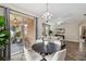 Bright dining area with table and chairs, open to the living room and patio at 5009 Torchwood Dr, Minneola, FL 34715
