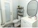 Small bathroom with white vanity, oval mirror, and modern toilet at 202 Sweetwater Club Blvd, Longwood, FL 32779