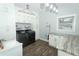 Laundry room with white cabinets, granite countertops, and modern washer and dryer at 202 Sweetwater Club Blvd, Longwood, FL 32779