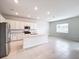 Modern kitchen with white cabinets and island at 10411 Park Estate Avenue, Orlando, FL 32836