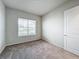 Spacious bedroom with neutral carpeting and large window at 10411 Park Estate Avenue, Orlando, FL 32836