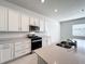 Modern kitchen with white cabinets and gas range at 10411 Park Estate Avenue, Orlando, FL 32836