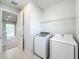 Convenient laundry room with washer, dryer, and shelving at 10411 Park Estate Avenue, Orlando, FL 32836
