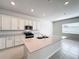 Open kitchen with white cabinets, large island, and stainless steel appliances at 10411 Park Estate Avenue, Orlando, FL 32836