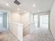 Upstairs hallway with neutral carpeting and doors to bedrooms at 10411 Park Estate Avenue, Orlando, FL 32836