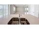 Kitchen island with double sink and view into adjoining living space at 10411 Park Estate Avenue, Orlando, FL 32836