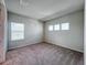 Well-lit bedroom with neutral walls and carpet, plus a window at 10411 Park Estate Avenue, Orlando, FL 32836