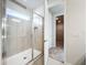 Shower with glass enclosure and neutral tile, and access to closet at 10411 Park Estate Avenue, Orlando, FL 32836
