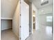 A hallway with a door leading to a bathroom and storage space at 10411 Park Estate Avenue, Orlando, FL 32836