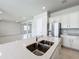 Open concept kitchen with island, stainless steel appliances, and white cabinets at 10411 Park Estate Avenue, Orlando, FL 32836