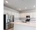 Modern kitchen with stainless steel appliances and white cabinets at 10411 Park Estate Avenue, Orlando, FL 32836