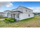 Two-story home with gray siding, stone accents, and a covered entryway at 10411 Park Estate Avenue, Orlando, FL 32836