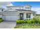 Two-story home with gray siding, stone accents, and a covered entryway at 10411 Park Estate Avenue, Orlando, FL 32836
