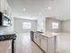 Open concept kitchen with island and stainless steel appliances at 10411 Park Estate Avenue, Orlando, FL 32836
