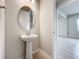 Modern bathroom with pedestal sink, bathtub, and tiled floors at 10411 Park Estate Avenue, Orlando, FL 32836