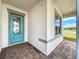 Covered entryway with light teal door and brick flooring at 10411 Park Estate Avenue, Orlando, FL 32836