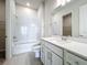 Clean bathroom with a bathtub, toilet, and vanity with a quartz top at 10411 Park Estate Avenue, Orlando, FL 32836