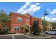 Two story townhome with orange exterior and landscaping at 8975 Candy Palm Rd, Kissimmee, FL 34747