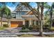 Two-story craftsman style home with large trees and landscaping at 11542 Brightstowe Way, Orlando, FL 32836