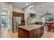 Kitchen boasts an island, stainless steel appliances, and ample cabinet space at 11542 Brightstowe Way, Orlando, FL 32836