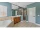 Elegant bathroom featuring a soaking tub, vanity, and glass shower enclosure at 11542 Brightstowe Way, Orlando, FL 32836