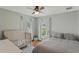 Bedroom with a king-size bed, crib, and plenty of natural light at 11542 Brightstowe Way, Orlando, FL 32836
