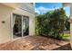 Brick paved patio with sliding glass doors leading to the house at 11542 Brightstowe Way, Orlando, FL 32836