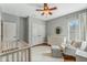 Light and airy Bedroom with a crib, dresser, and ample closet space at 11542 Brightstowe Way, Orlando, FL 32836