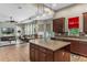 Open concept kitchen with island, stainless steel appliances, and Gathering room view at 11542 Brightstowe Way, Orlando, FL 32836