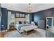 Spacious main bedroom with a navy blue accent wall, king bed and dresser at 11542 Brightstowe Way, Orlando, FL 32836