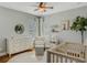 Charming Bedroom featuring a crib, dresser, and rocking chair at 11542 Brightstowe Way, Orlando, FL 32836