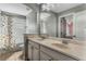 Bathroom with dual sinks, tub, and dinosaur-themed shower curtain at 11542 Brightstowe Way, Orlando, FL 32836