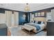 Main bedroom with king-size bed, navy walls, and access to backyard at 11542 Brightstowe Way, Orlando, FL 32836