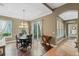 Bright dining room features a wood floor, chandelier, and access to the backyard at 11542 Brightstowe Way, Orlando, FL 32836