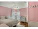 Charming bedroom with a queen-size bed and soft pink walls at 11542 Brightstowe Way, Orlando, FL 32836