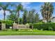 Community entrance with a beautiful landscape and signage at 11542 Brightstowe Way, Orlando, FL 32836