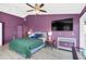 Main bedroom with a green comforter and a large TV at 621 E Wildmere Ave, Longwood, FL 32750
