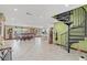 Open living area with spiral staircase, tile floors, and water views at 621 E Wildmere Ave, Longwood, FL 32750