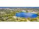 Aerial view of a house near a lake in a residential neighborhood at 621 E Wildmere Ave, Longwood, FL 32750