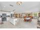 Open concept kitchen with island, stainless steel appliances, and views to dining and living areas at 621 E Wildmere Ave, Longwood, FL 32750