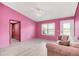 Living room with a pink wall and comfortable couch at 621 E Wildmere Ave, Longwood, FL 32750