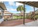 Relaxing lower deck overlooking a lake view, with hot tub and playset at 621 E Wildmere Ave, Longwood, FL 32750
