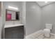 Modern bathroom with gray vanity and a toilet at 621 E Wildmere Ave, Longwood, FL 32750