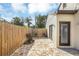 Stone patio with seating area and wooden privacy fence at 621 E Wildmere Ave, Longwood, FL 32750