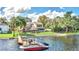 Aerial photo of a lakefront home with a dock and boat at 621 E Wildmere Ave, Longwood, FL 32750