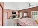 Comfortable bedroom with a TV and plenty of space at 621 E Wildmere Ave, Longwood, FL 32750